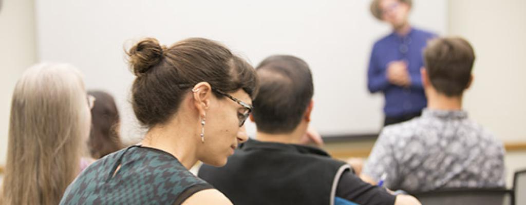 A room of people in attendance at a meeting